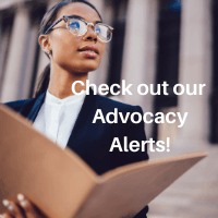 Pensive African American female lawyer in stylish formal suit holding folder with mock up area and looking away standing against courthouse. Text reads "Check out our Advocacy Alerts!"