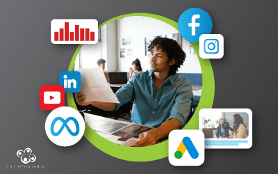 a black man wearing a blue long-sleeve shirt sits at a desk with a piece of paper in front of him and several images on a desk in front of him. Around him are various social media icons