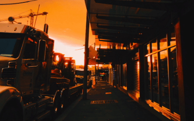 a photo of over the road trucks stopped at a location in the sunset