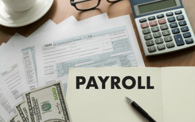 a picture of taxes, with the word 'payroll' on a piece of paper