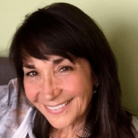 a white woman with shoulder-length dark brown hair